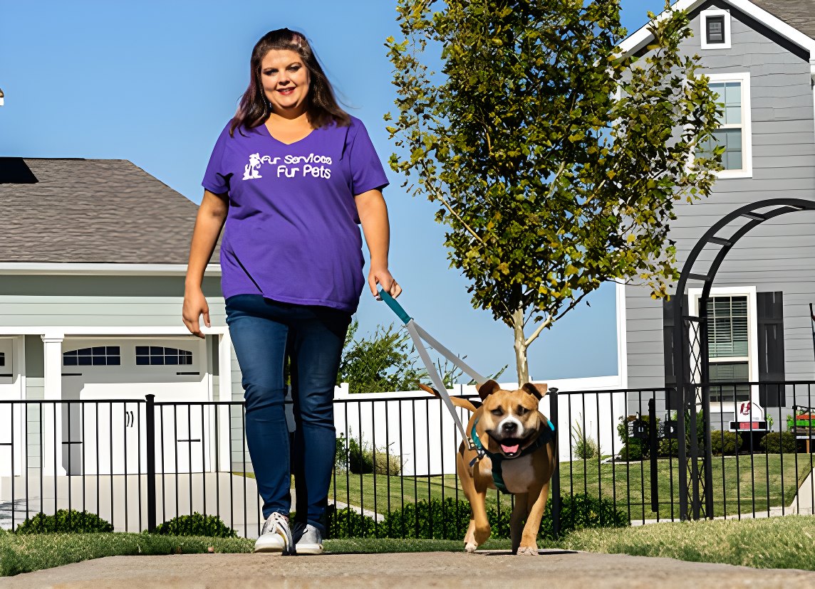 A Fur Services Fur Pets Pet Companion walking a leashed dog along a sidewalk